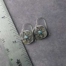 Load image into Gallery viewer, Silver earrings with blue stones on a gray surface next to a ruler.