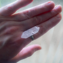 Load image into Gallery viewer, A hand displaying a clear, double-terminated rose quartz crystal ring on a finger.