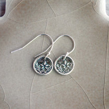 Load image into Gallery viewer, Silver earrings with intricate designs on a beige surface