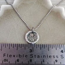Load image into Gallery viewer, A silver flower pendant necklace with a vintage design, featuring a morning glory flower motif, displayed with a ruler for scale