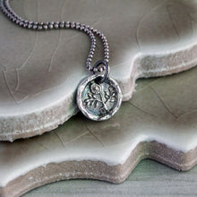Load image into Gallery viewer, A silver flower pendant necklace with a vintage design, featuring a morning glory flower motif, displayed on a textured background.
