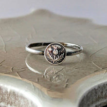 Load image into Gallery viewer, Silver ring with a circular floral design on a textured surface