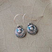 Load image into Gallery viewer, Silver thistle earrings on a textured beige surface