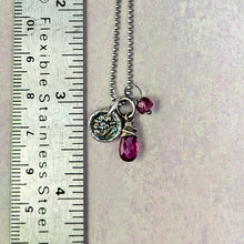 Load image into Gallery viewer, Necklace with pink gemstone and silver charms next to a ruler for scale