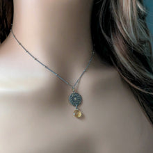 Load image into Gallery viewer, Necklace with a pendant featuring a yellow gemstone and intricate design on a person's neck.