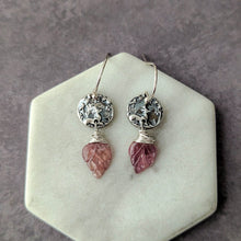 Load image into Gallery viewer, Pair of earrings with pink gemstones and silver accents on a stone surface