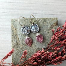 Load image into Gallery viewer, Silver earrings with pink gemstones on a stone surface with dried red flowers.