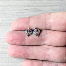 Load image into Gallery viewer, Small silver earrings with pink stones held between fingers on a light gray background