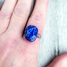 Load image into Gallery viewer, Blue stone ring on a finger for scale