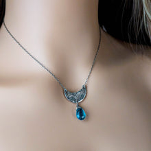 Load image into Gallery viewer, Silver crescent moon pendant with blue teardrop gemstone on a person's neck