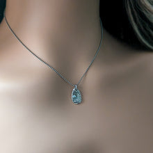 Load image into Gallery viewer, Silver pendant necklace with blue gemstone on a mannequin