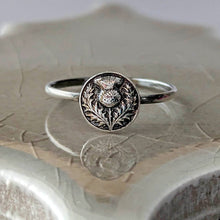 Load image into Gallery viewer, Silver ring with intricate design on a textured surface