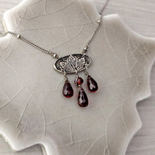 Load image into Gallery viewer, Necklace with a detailed oval pendant and garnet beads