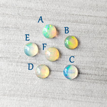 Load image into Gallery viewer, Opal stones labeled A to F on a textured gray surface