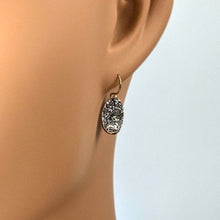 Load image into Gallery viewer, Silver textured earring on a mannequin ear against a light background