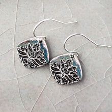 Load image into Gallery viewer, Silver floral earrings on a textured light gray surface