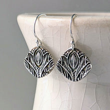 Load image into Gallery viewer, Silver earrings with intricate designs on a textured white surface