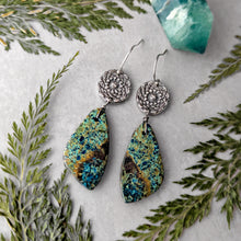 Load image into Gallery viewer, Pair of silver earrings with green and blue marbled teardrop pendants on a white surface with green leaves.
