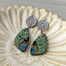 Load image into Gallery viewer, Pair of silver earrings with green and brown stone drops on a shell shaped dish