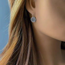 Load image into Gallery viewer, Close-up of a silver earring on a mannequin against a blue background
