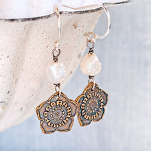 Load image into Gallery viewer, A pair of bohemian-style dangle earrings with oxidized bronze flower charms, and a chunky raw pearl bead, hanging from silver fishhook wires.
