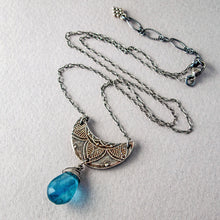 Load image into Gallery viewer, Overview of entire silver crescent moon pendant with blue teardrop gemstone, showing the detailed extender chain, on a textured beige surface
