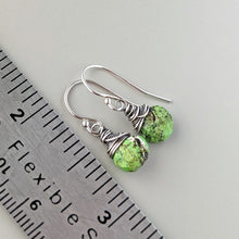 Load image into Gallery viewer, Green stone earrings with silver wire wrapping next to a ruler for scale
