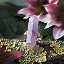 Load image into Gallery viewer, Amethyst crystal ring on a branch with pink flowers in the background
