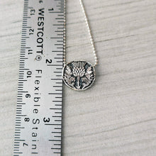 Load image into Gallery viewer, Silver necklace with a thistle pendant next to a ruler on a light gray background
