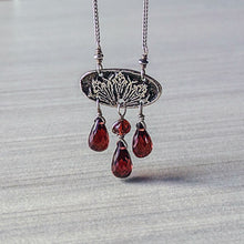 Load image into Gallery viewer, Necklace with red teardrop pendants on a textured gray background
