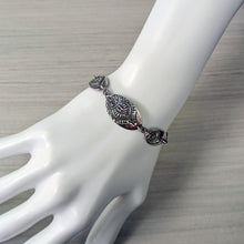 Load image into Gallery viewer, Silver bracelet on a mannequin hand against a neutral background
