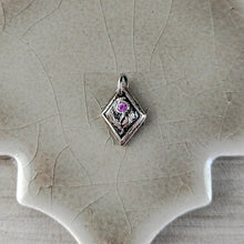 Load image into Gallery viewer, Fin silver pendant with a pink gemstone on a ceramic surface
