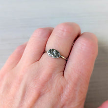 Load image into Gallery viewer, Silver ring with intricate design on a person&#39;s finger against a neutral background
