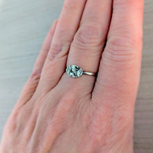 Load image into Gallery viewer, Silver ring with a deer design on a person&#39;s finger against a neutral background
