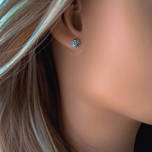 Load image into Gallery viewer, Close-up of an ear wearing a small round silver earring with a blurred background
