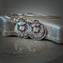 Load image into Gallery viewer, Silver earrings with intricate designs on a textured surface
