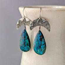 Load image into Gallery viewer, Pair of earrings with blue teardrop-shaped stones and silver floral designs on a light background
