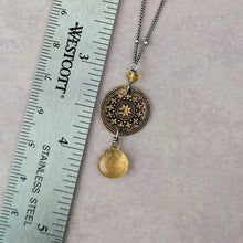 Load image into Gallery viewer, Necklace with decorative pendant next to a ruler on a light gray background
