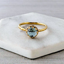 Load image into Gallery viewer, Gold ring with a blue green gemstone on a white stone surface
