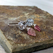 Load image into Gallery viewer, Silver earrings with pink leaf-like stones on a stone surface
