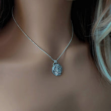 Load image into Gallery viewer, Silver necklace with a pendant on a person's neck
