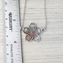Load image into Gallery viewer, Floral pendant necklace with a pink center on a light gray background, next to a ruler for scale.
