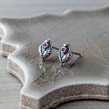 Load image into Gallery viewer, Silver earrings with red gemstones on a textured white surface
