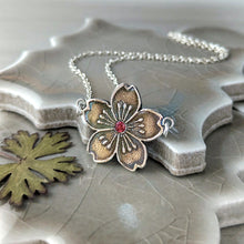 Load image into Gallery viewer, Floral pendant necklace with a red gemstone on a ceramic surface
