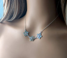 Load image into Gallery viewer, Silver floral necklace with rubies on a mannequin with a neutral background
