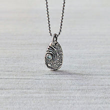 Load image into Gallery viewer, Silver pendant necklace with blue gemstone on a textured light gray background
