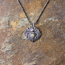 Load image into Gallery viewer, A silver spider with a smooth opal stone set into the abdomen laying flat on a stone tile
