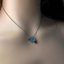Load image into Gallery viewer, Necklace with silver and pink gemstone charms shown on a mannequin.
