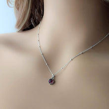 Load image into Gallery viewer, Silver necklace with a dark red gemstone pendant on a mannequin
