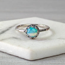 Load image into Gallery viewer, Silver ring with a colorful gemstone on a marble surface
